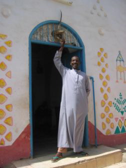 Mustafa in front of a Nubian House