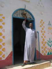 Mustafa in front of a Nubian House