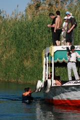 Local boys catch a ride on the Nile - Aswan, Egypt